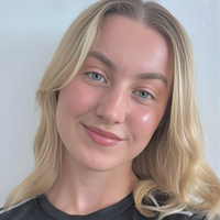 Headshot of Alice smiling at camera.