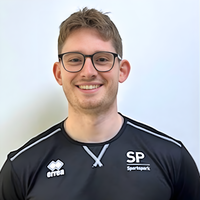 Headshot of Alastair smiling at camera.