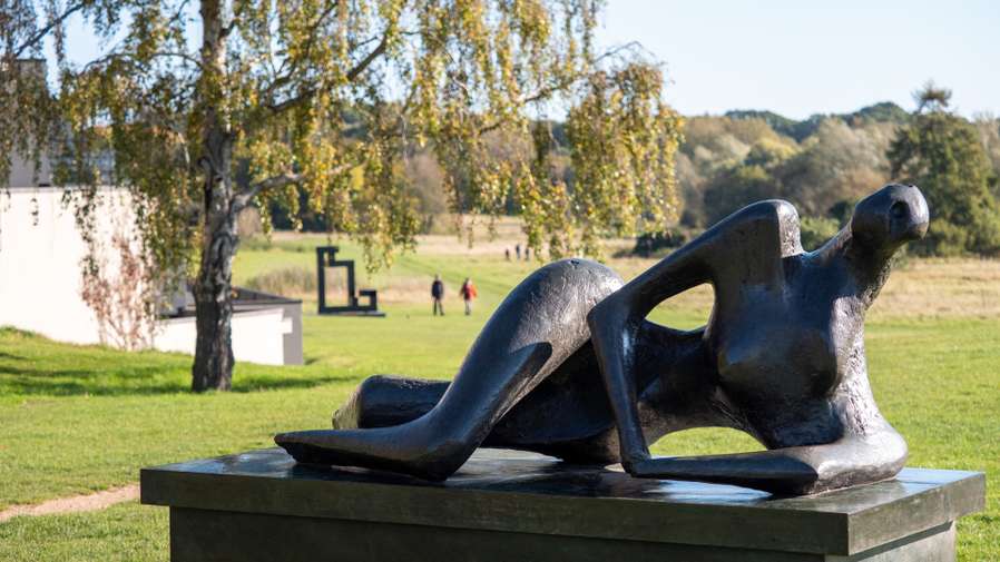 Image of Henry Moore's Reclining Figure sculpture in the grounds of the Sainsbury Centre Sculpture Park.