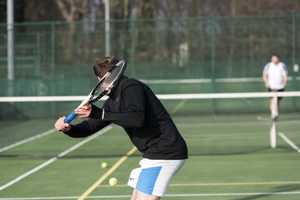 tennis player outdoors hitting ball