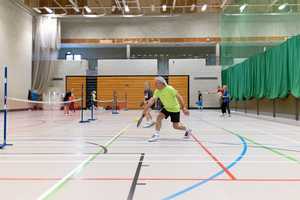 people playing pickleball matches in sports hall
