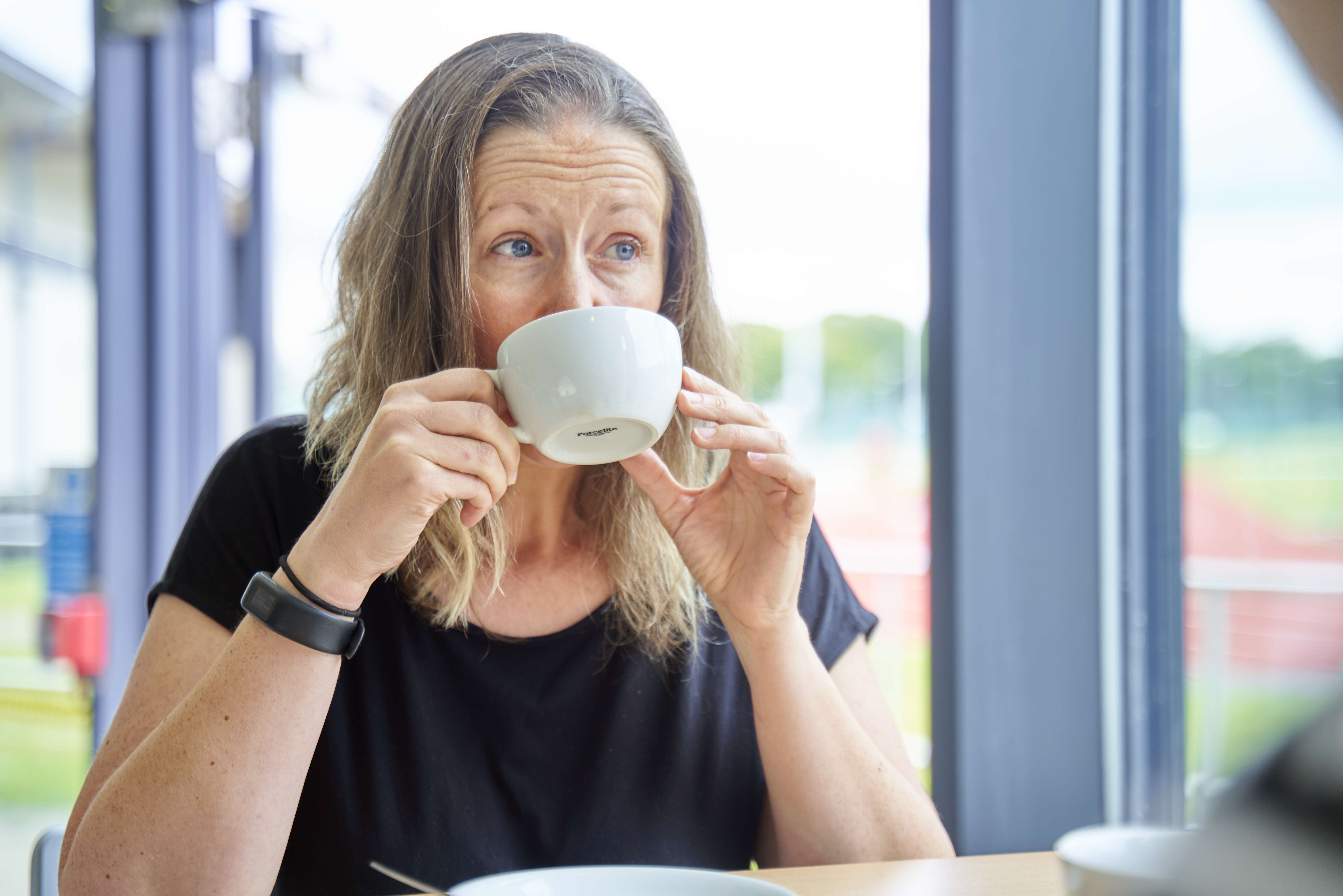 person drinking from a mug in sportscafe