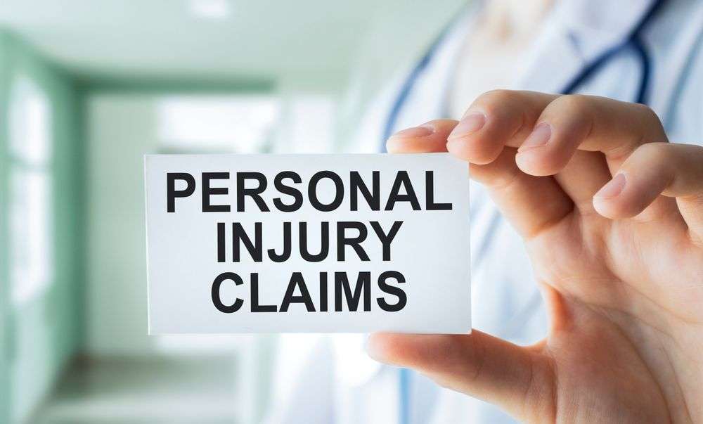 hand holding card that says personal injury claims