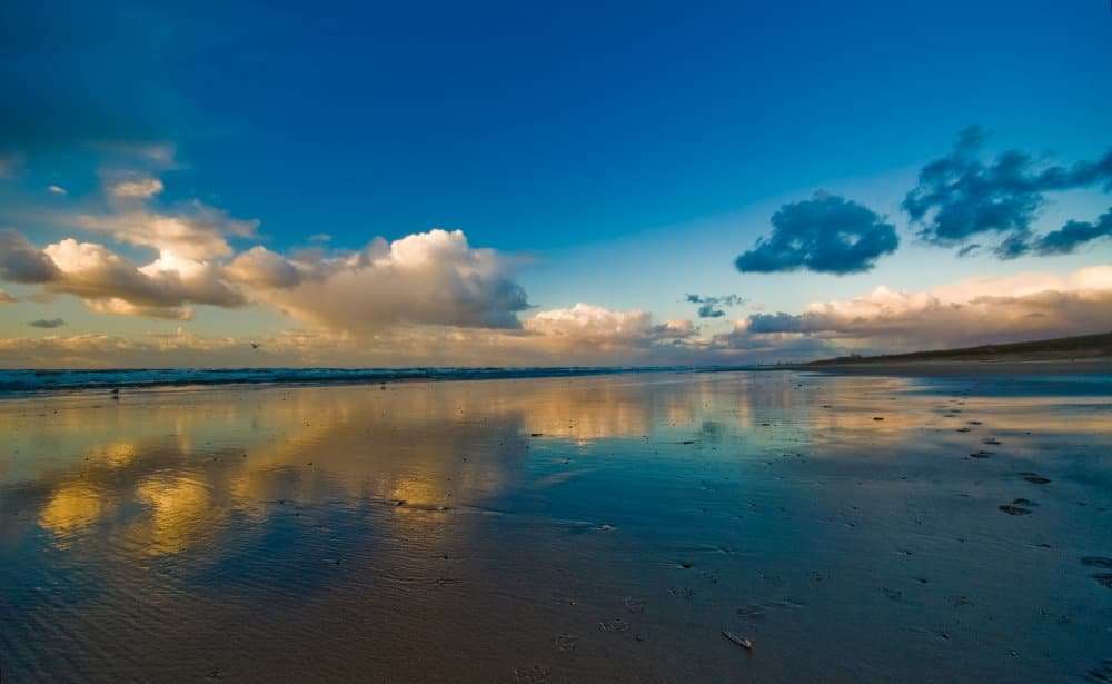 A sunset reflection of clouds on water