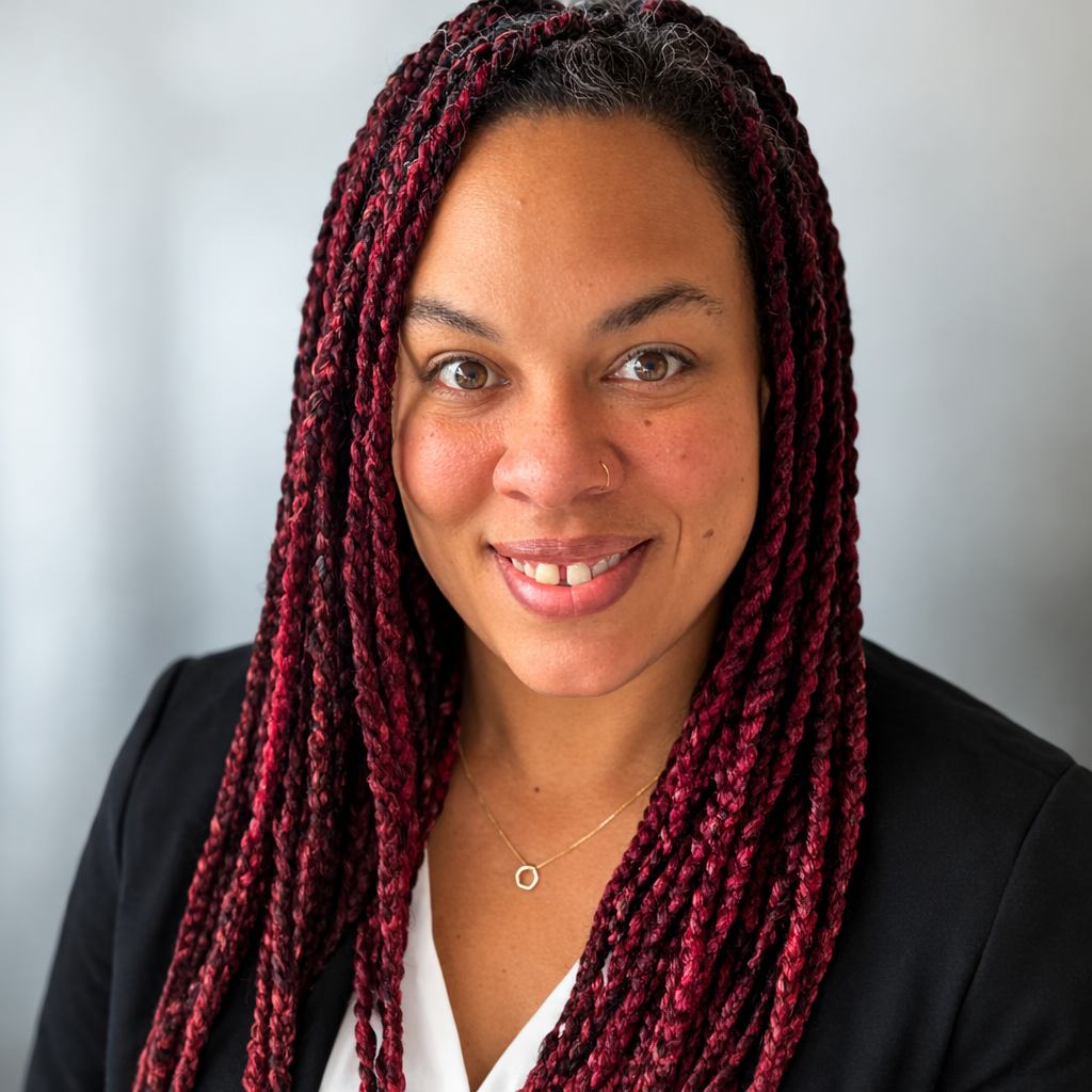 A portrait photo of someone smiling at the camera.