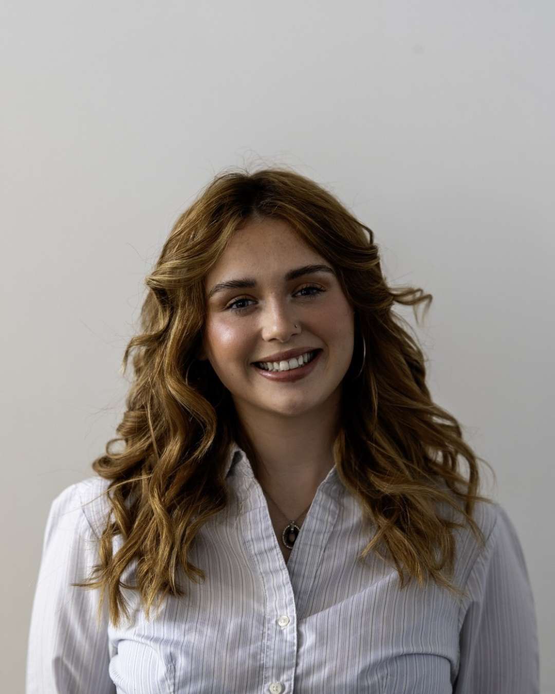 A portrait photo of someone smiling at the camera.