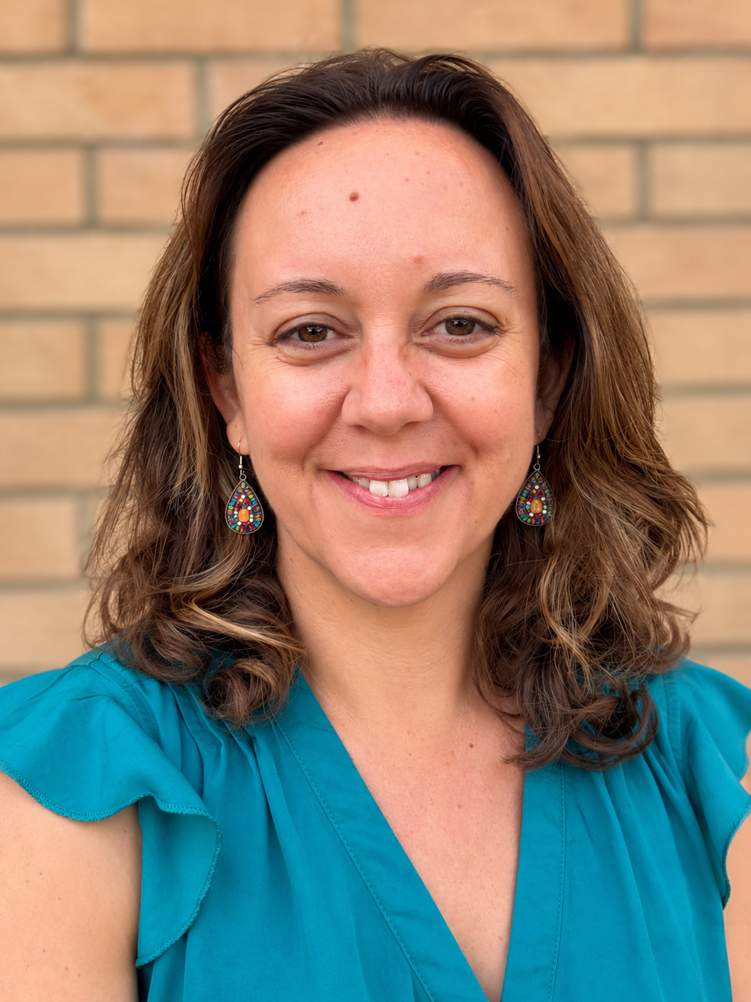 A portrait photo of someone smiling at the camera.