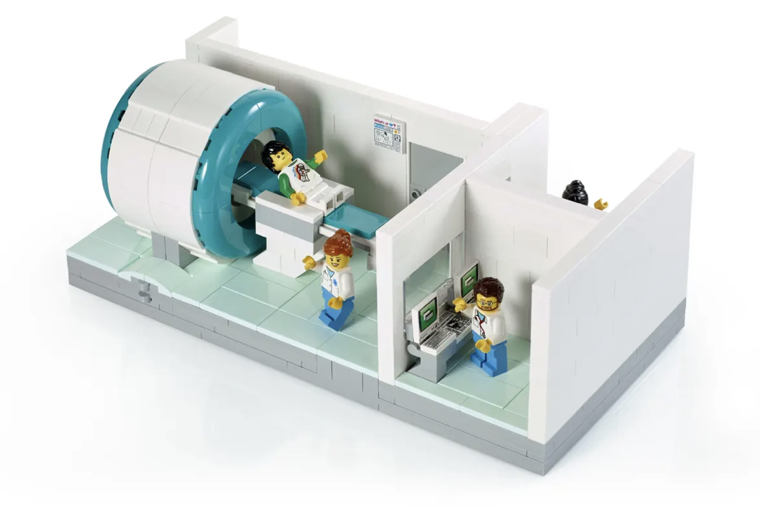 A colourful digital photograph of a MRI Lego set with characters involved in having an MRI scan
