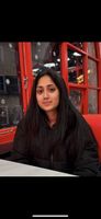 Woman sat in front of red building