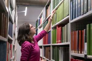 Imagination-Woman_reaching_for_a_book.jpg