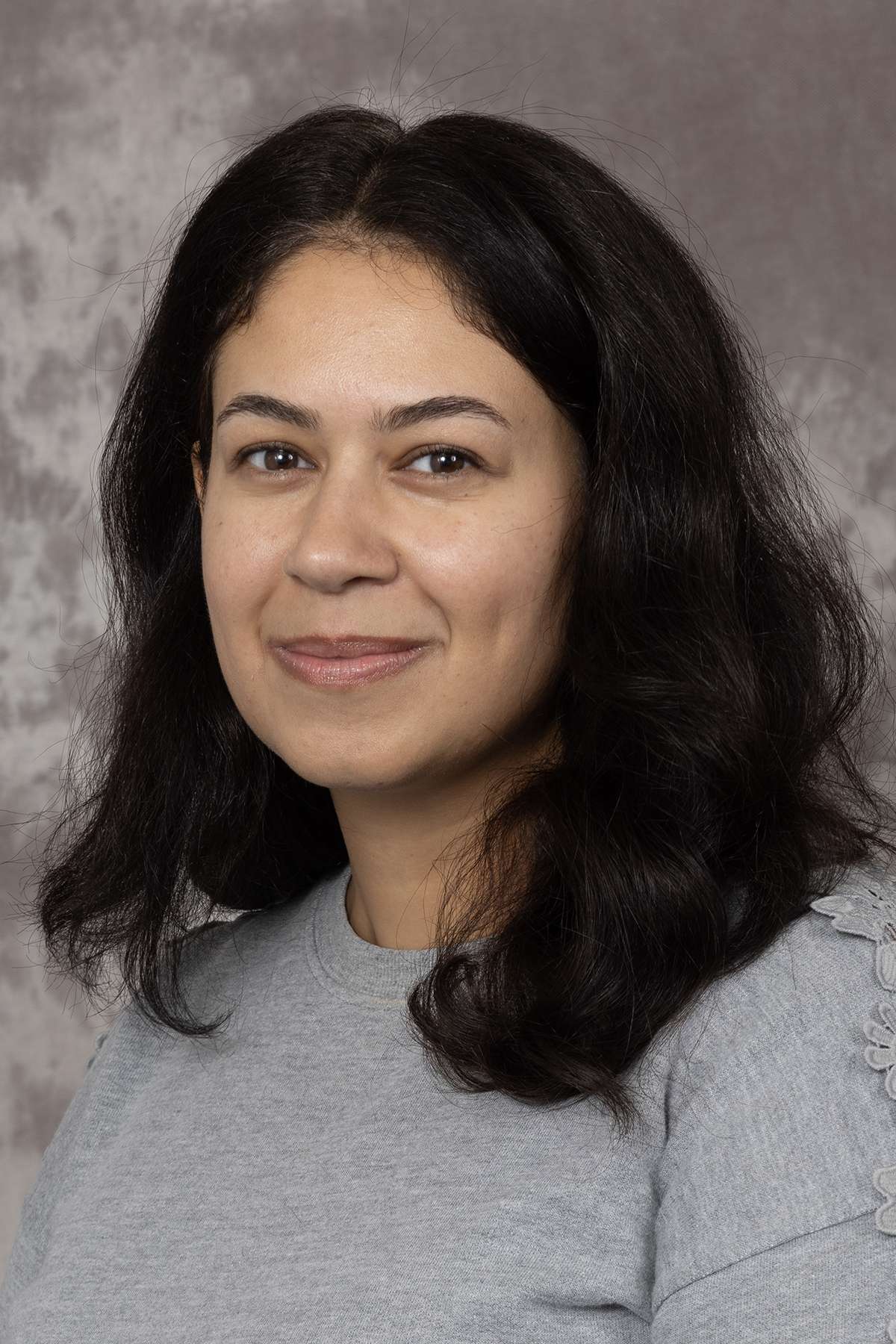A portrait photo of someone smiling at the camera.