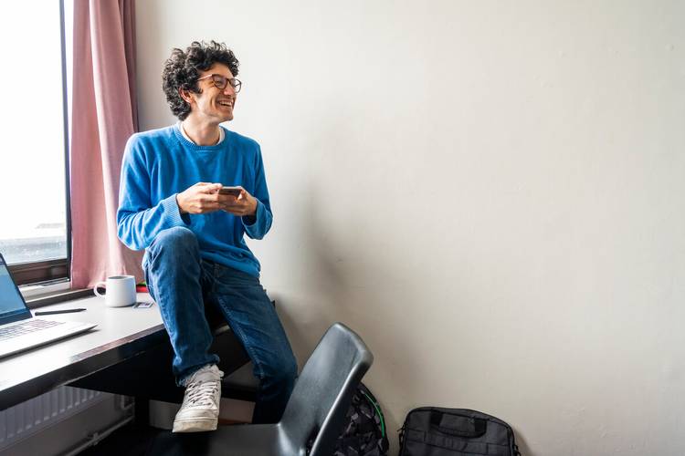 Student sat inside accommodation
