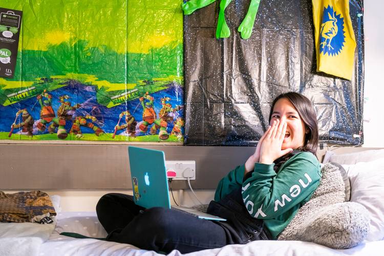 Student with laptop in accommodation