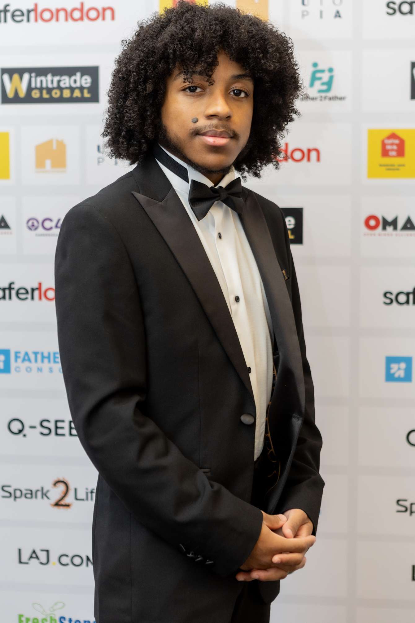 A portrait photo of someone dressed in a tuxedo.