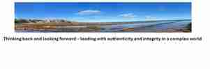 Panoramic view of a coastal landscape with rocky shoreline and blue sky, accompanied by text about leadership and integrity.