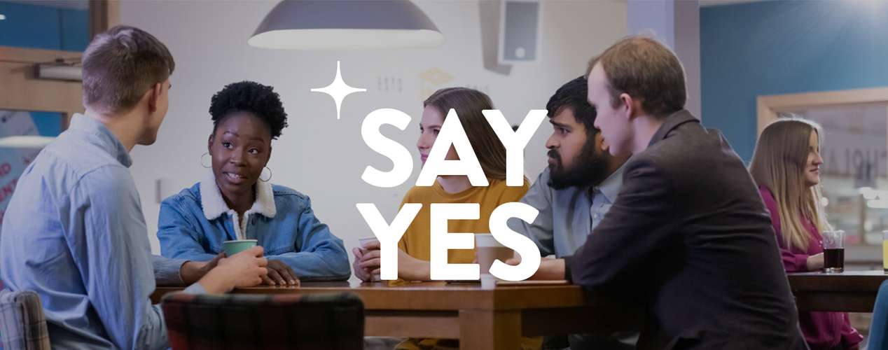 Students mid conversation at coffee shop