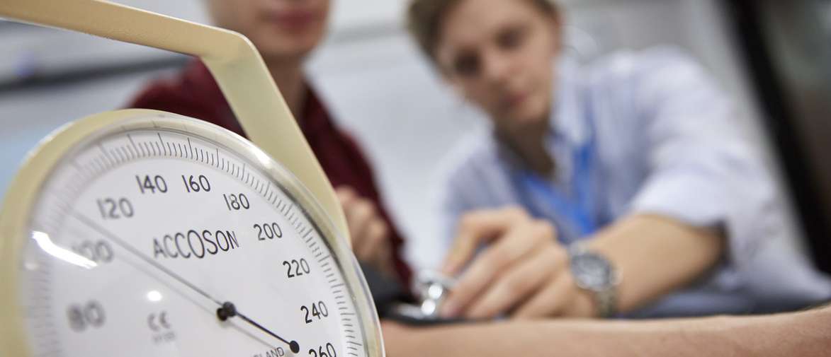 person measuring blood pressure 