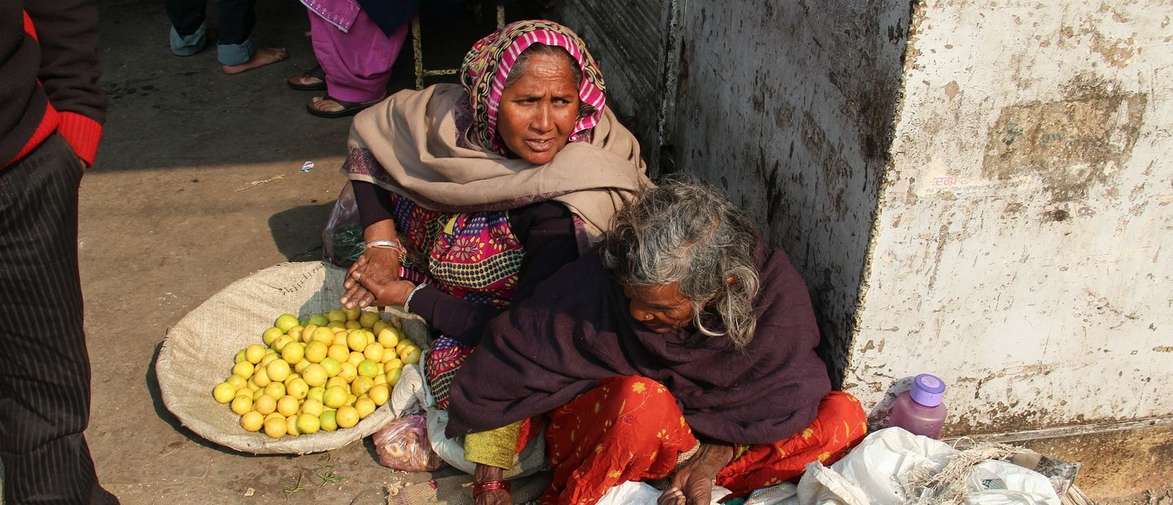 Women sitting on floor in street