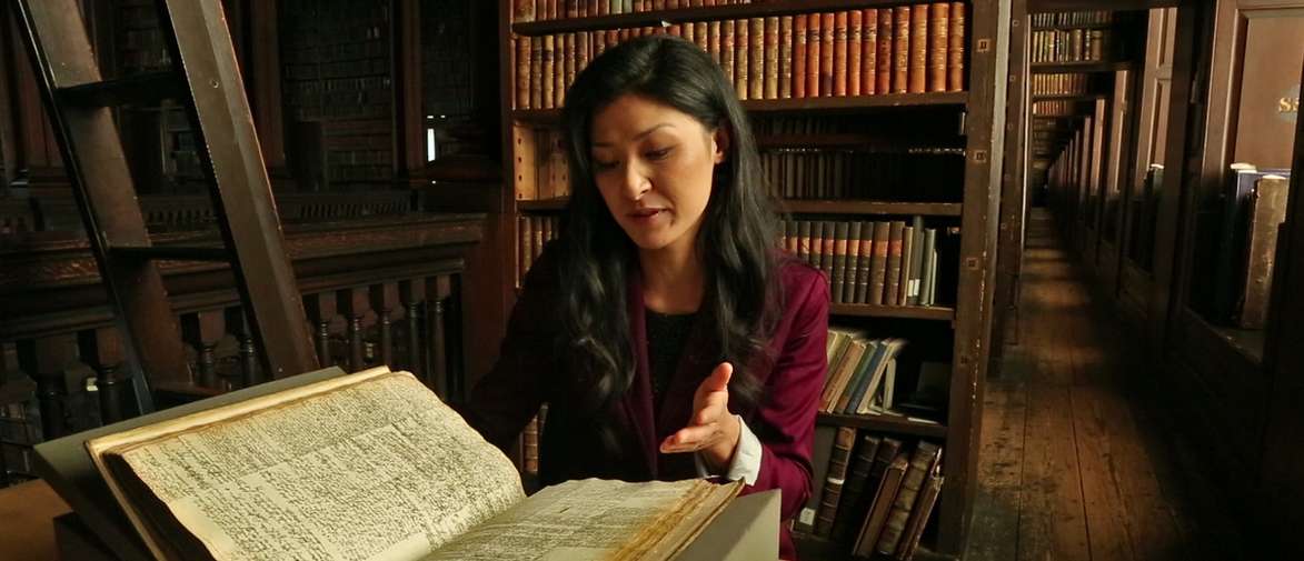 Picture of Polly Ha looking at archive material