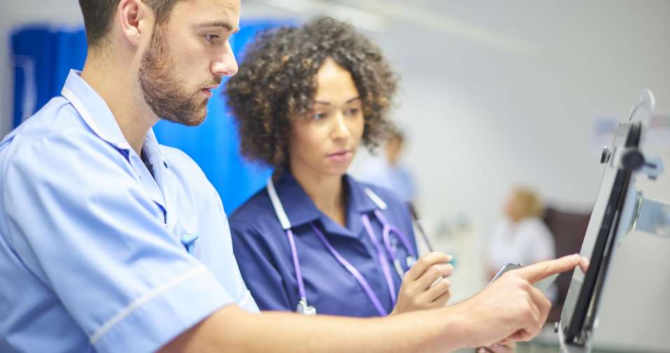 HSC male and female nurse examining monitor