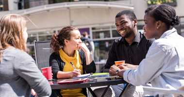 students talking around table