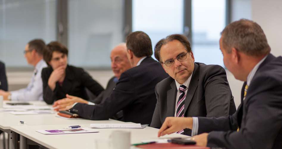 Group of people talking by a table