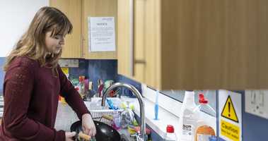 Student in UEA halls washing a wok without water