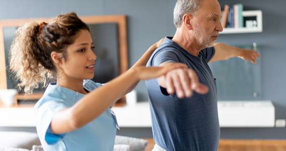physiotherapist with client