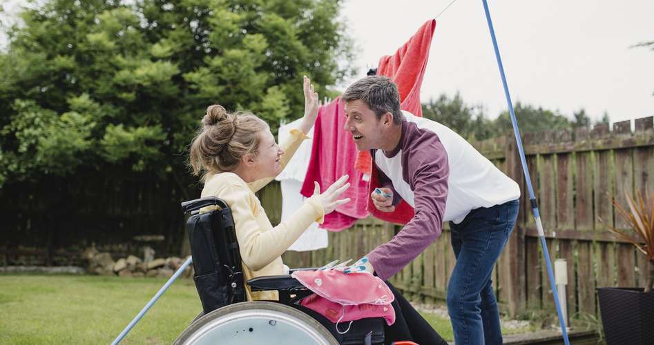 girl with disability and carer