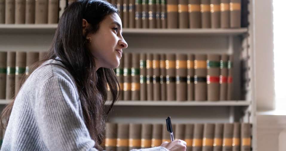 student by bookcase