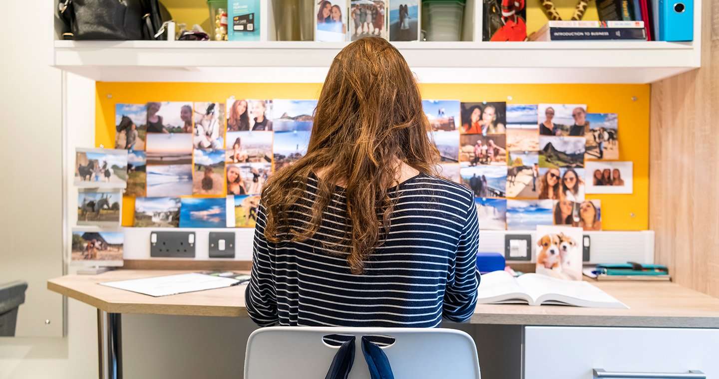 Student at bedroom desk in UEA accommodation