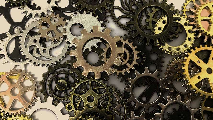 Metal cogs scattered on white floor