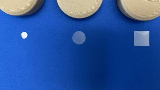 three prototypes of dries skincare product on blue background