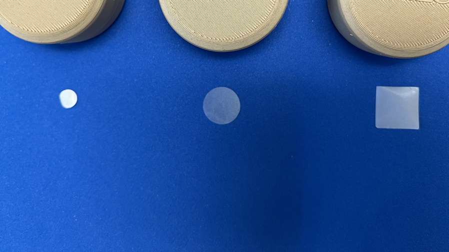 three prototypes of dries skincare product on blue background