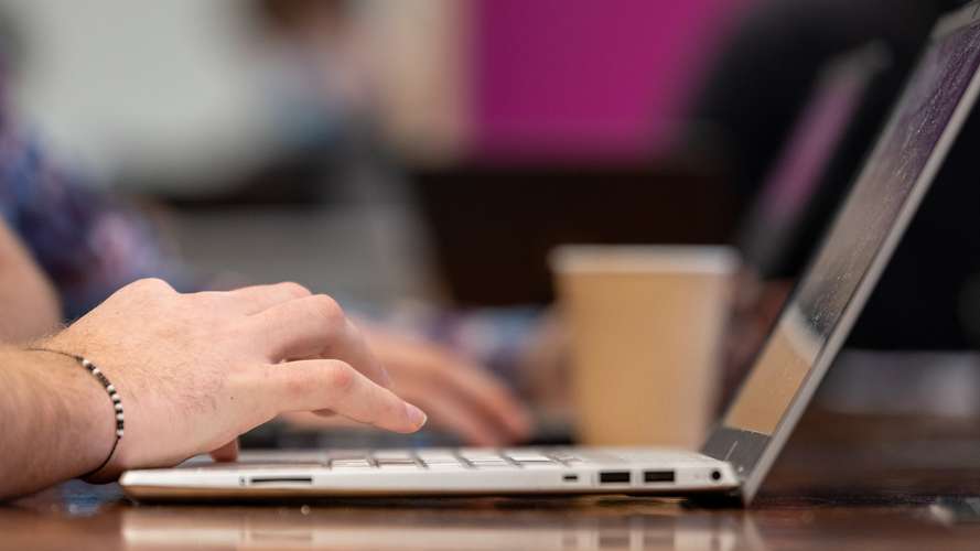 Hands using a laptop at UEA