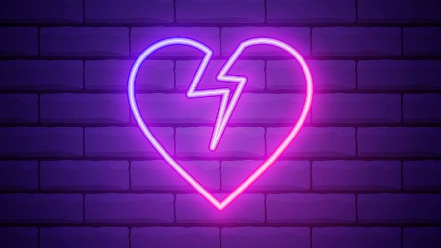 neon broken heart on wall graphic