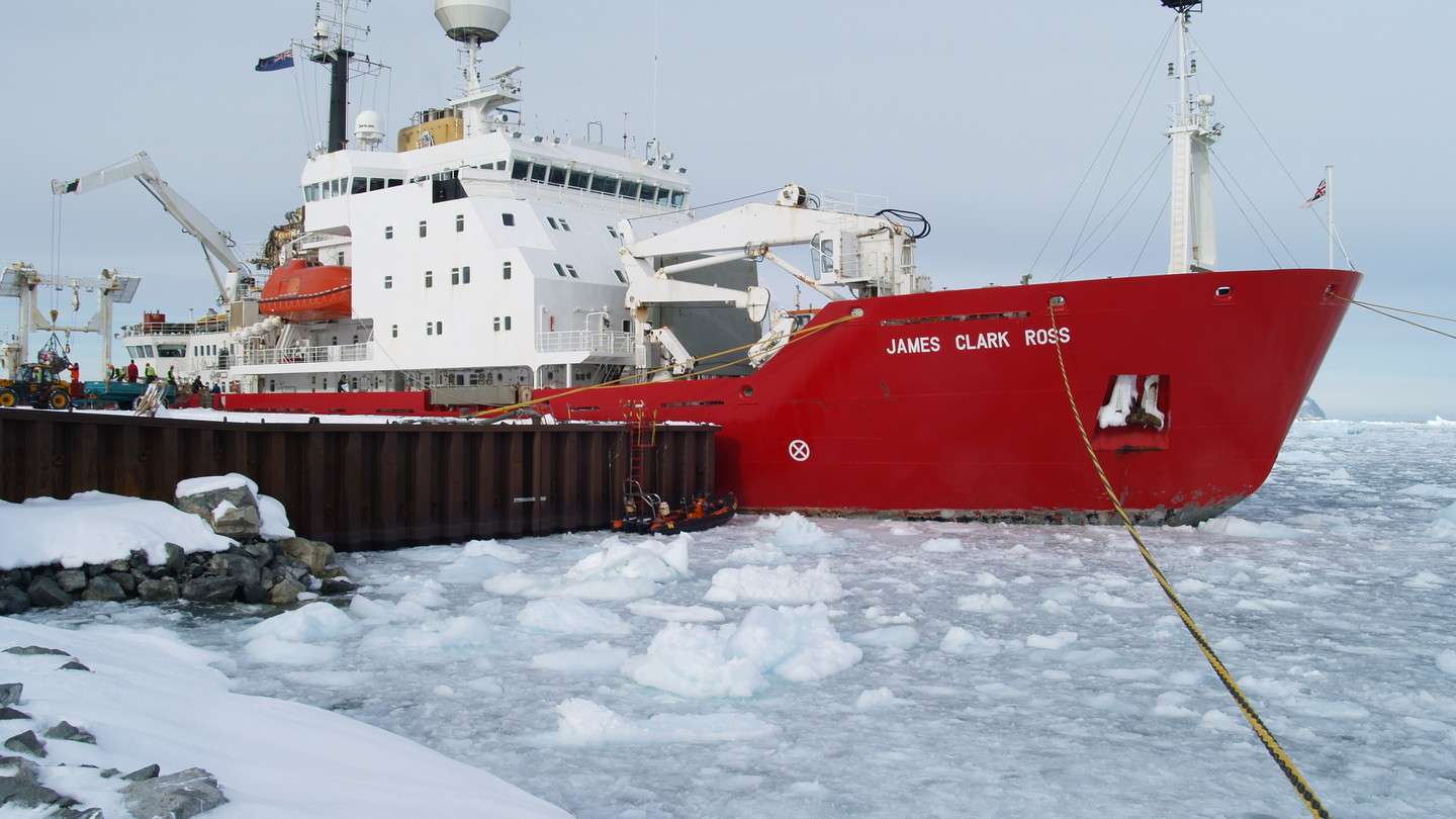 Research boat among icebergs and broken ice