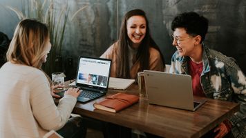 People laughing around a table