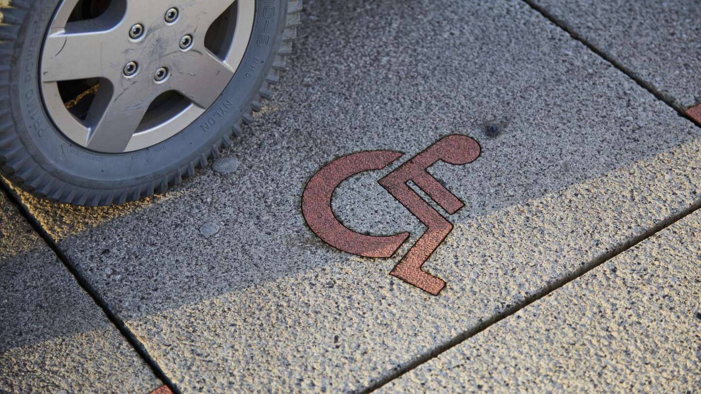 wheel next to wheelchair symbol on ground