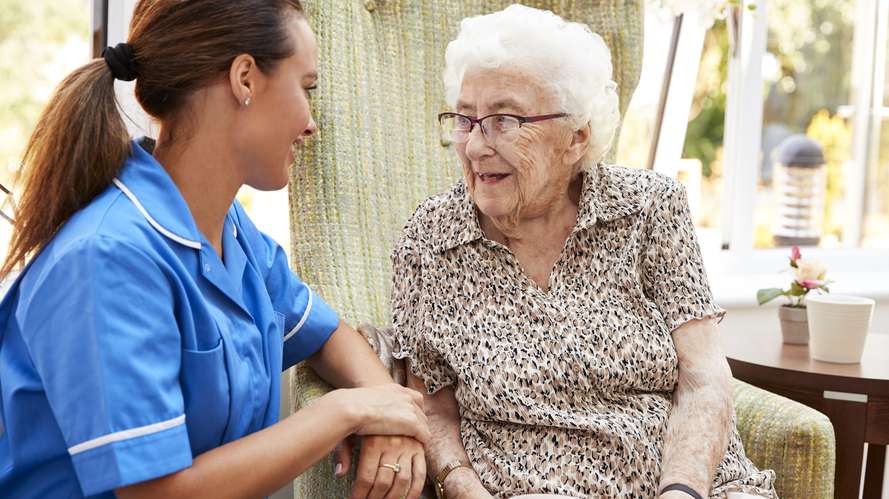 nurse talking with elderly woman 