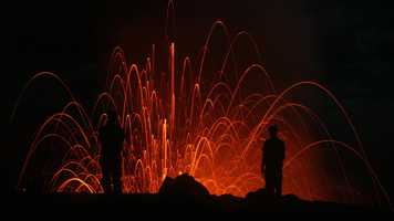 volcano erupting at night