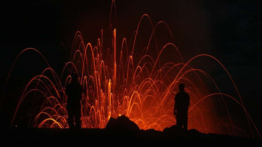 volcano erupting at night