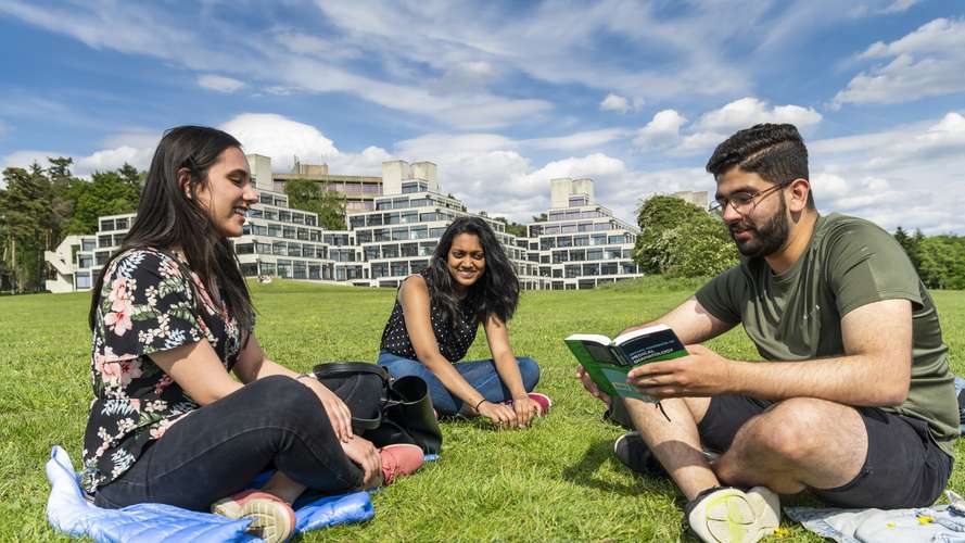 Students sat by the broad in the sun