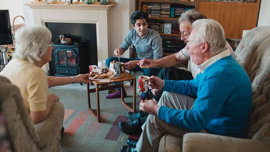 carer in living room with family