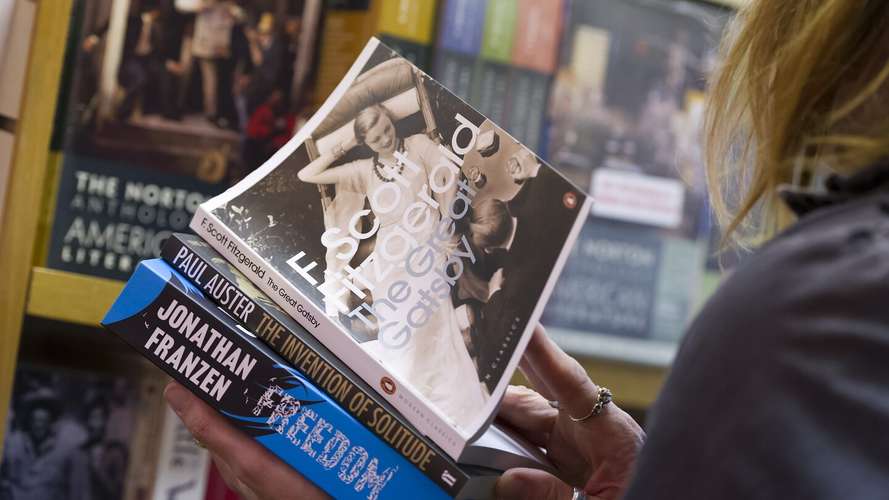 A UEA student holding American books