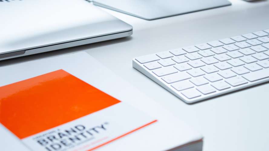 brand identity book, laptop and keyboard