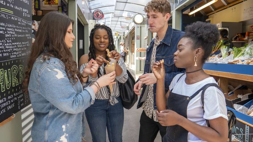 students eating food at Norwich market