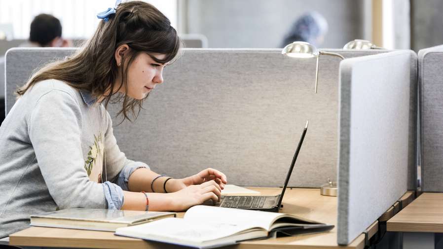 Students on campus in the Library