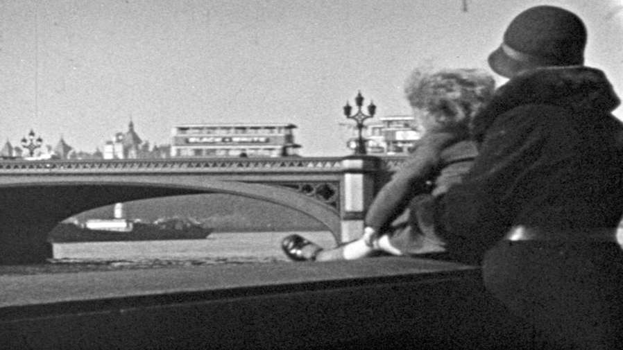 black and white photo of a woman looking over Westminster