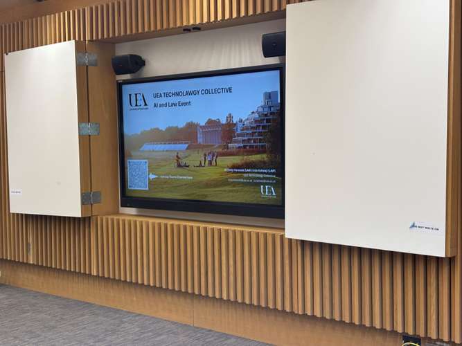industry_niche: Higher Education in Norwich, United Kingdom brand_product_service: Public facing website for marketing research and courses.target_audience: Undergraduate, Postgraduate students, and Researchersalt: The UEA Technology Collective's "AI and Law Event" is promoted on a screen in a modern lecture hall, showing the university's Ziggurats.